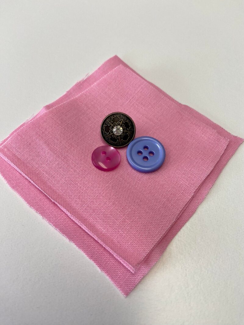 three buttons and fabric