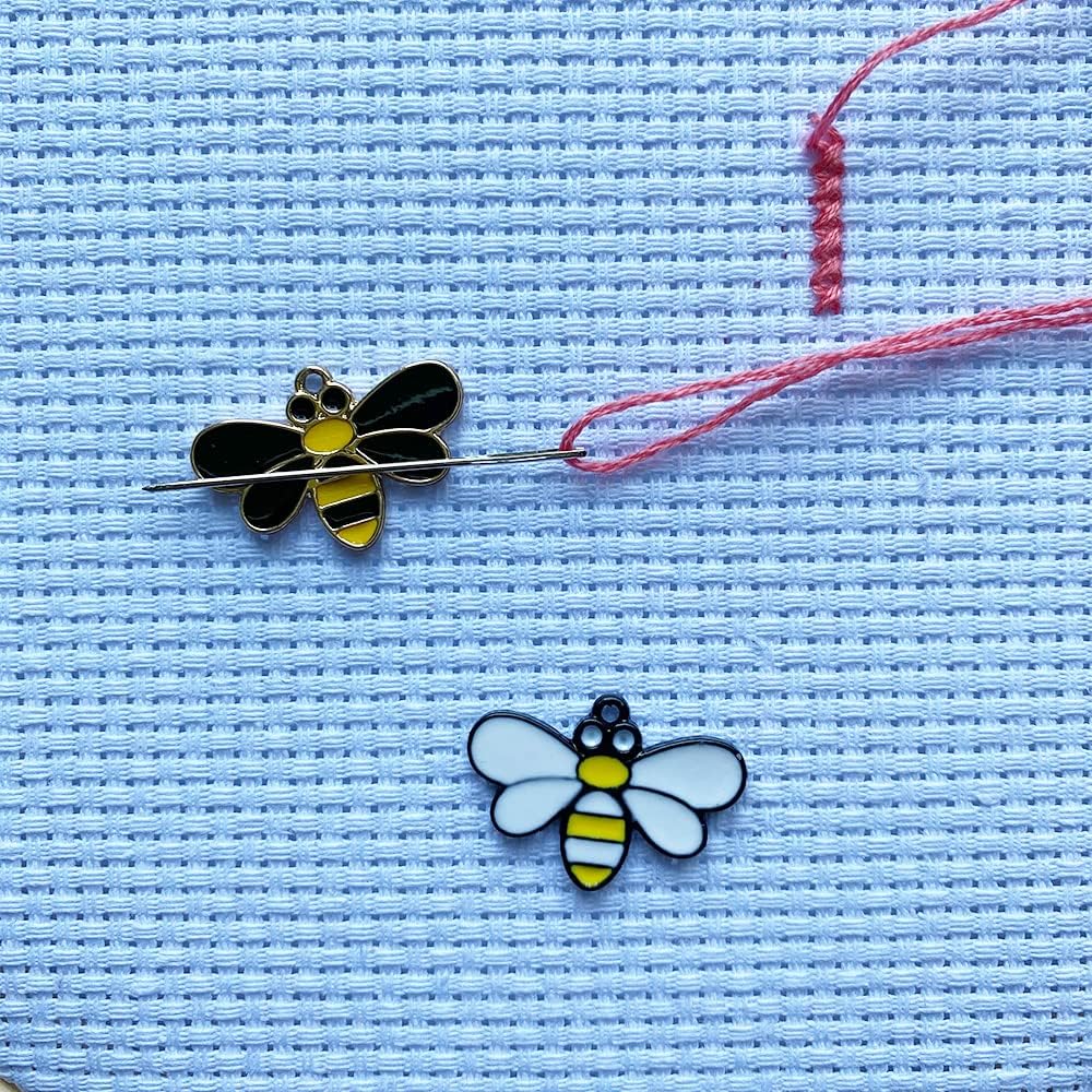 bee needle minders on blue fabric