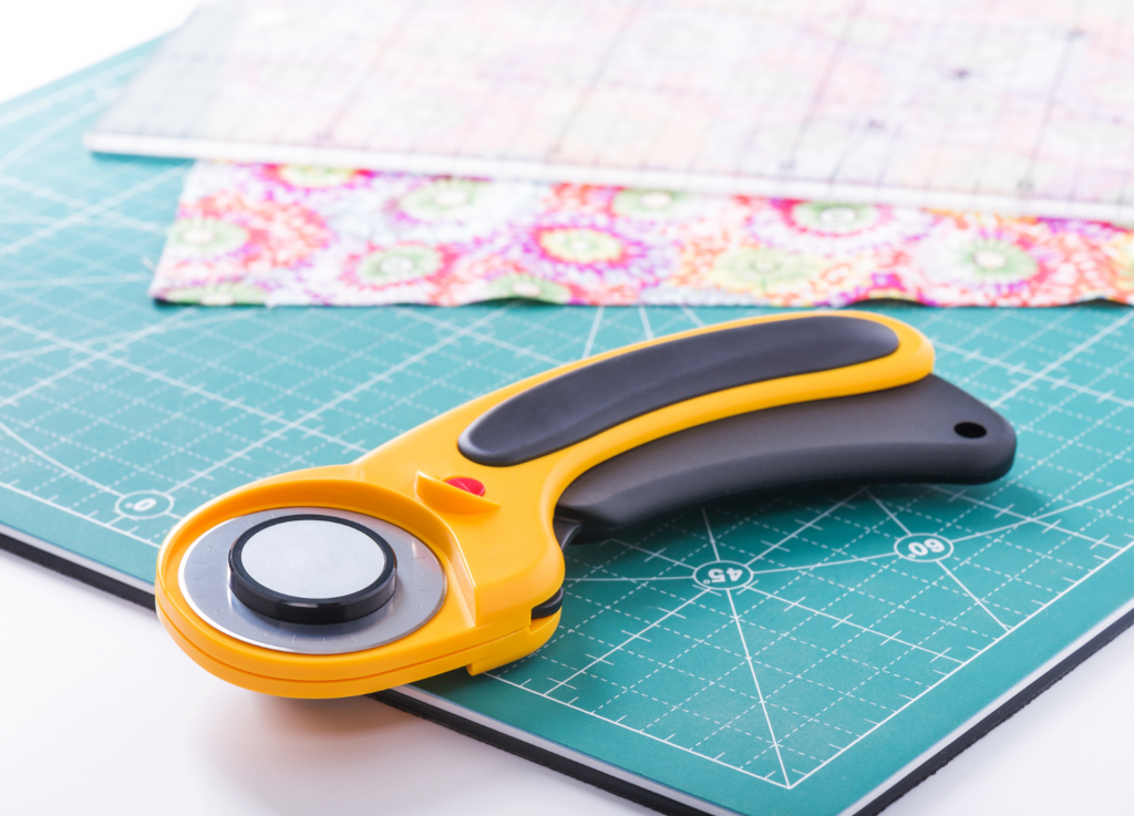 rotary cutter and fabric on table.