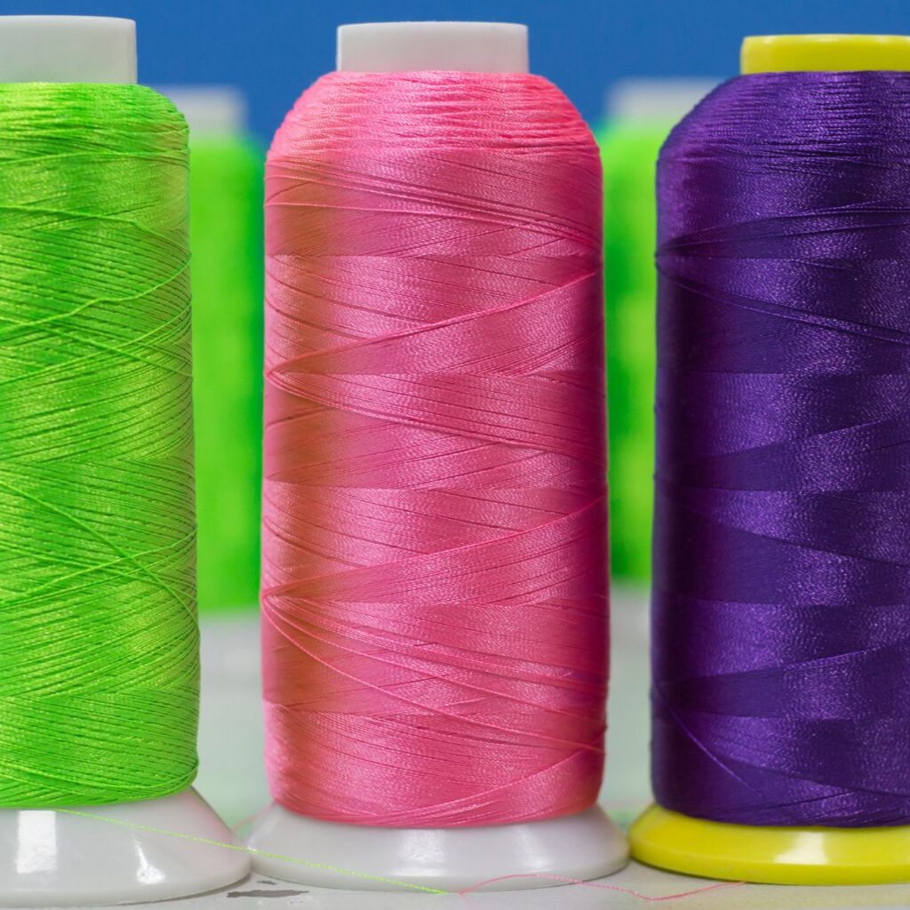 three spools of embroidery thread on a table