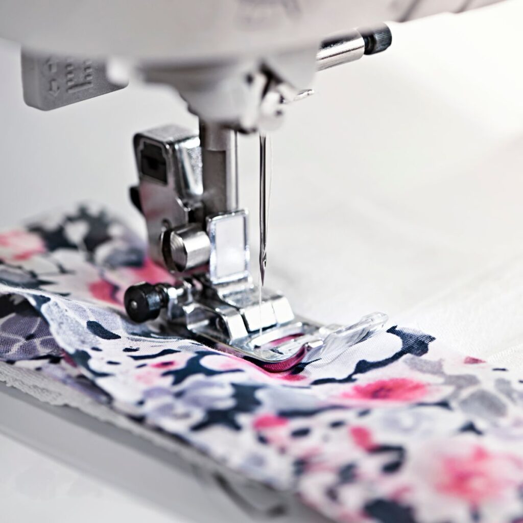 sewing machine needle and floral fabric.
