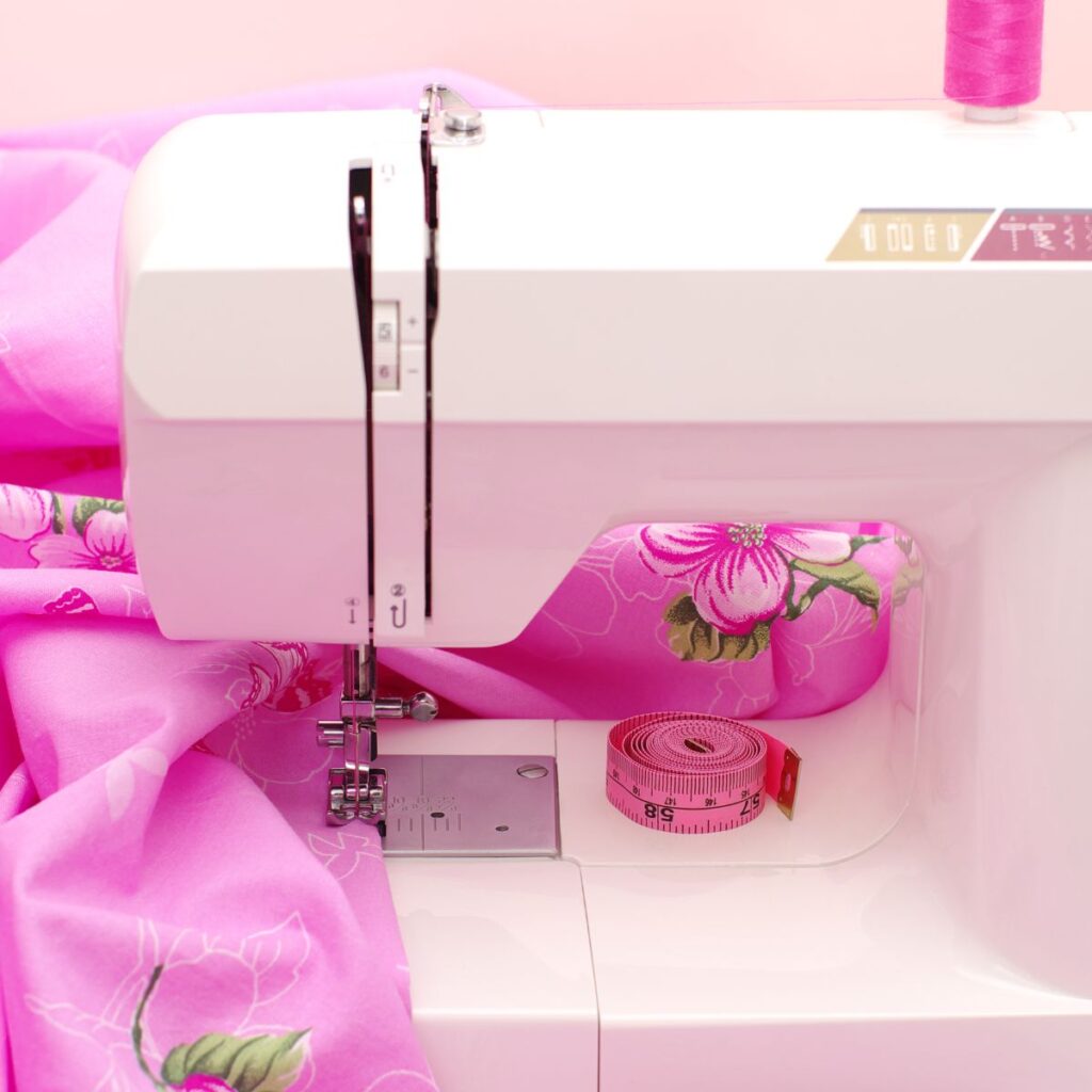 Sewing machine and pink fabric.